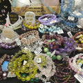 Collection of beaded bracelets on display with price tags.