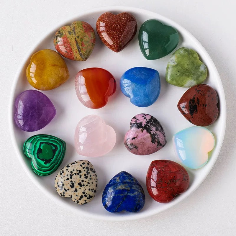 Assorted heart-shaped colorful stones on a white plate
