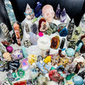Collection of various crystals and gemstones on a white surface
