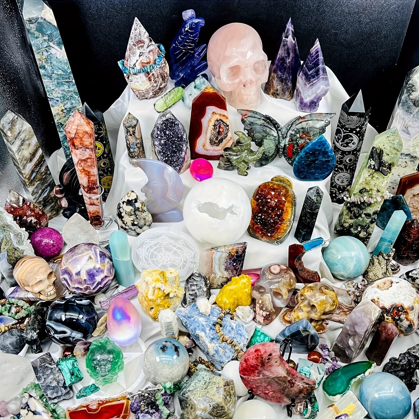 Collection of various crystals and gemstones on a white surface