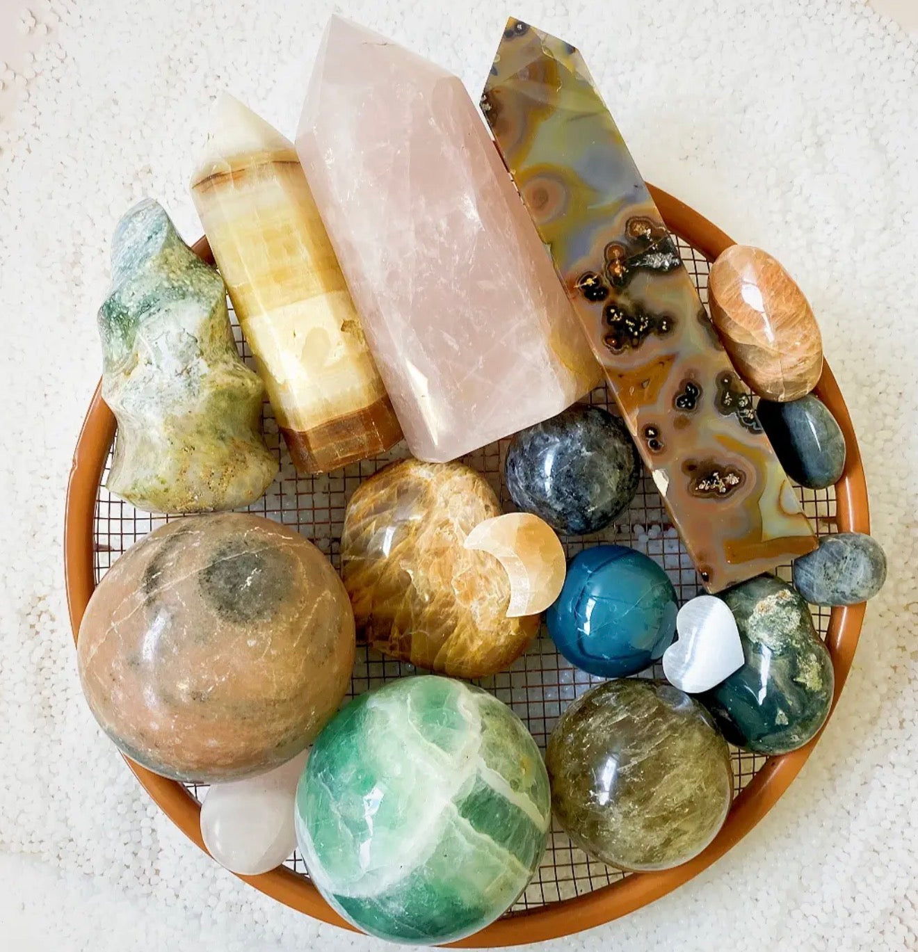 Collection of various polished stones on a textured surface