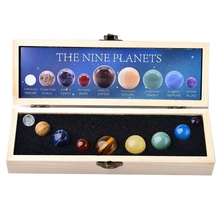 Model of the nine planets in a wooden box with a display case.